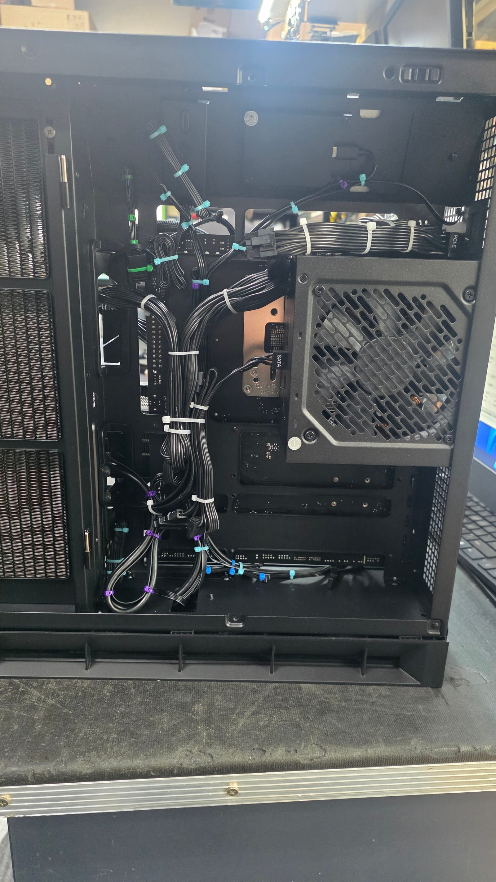 A closer view of the power supply bay cabling, routed and zip-tied by colour