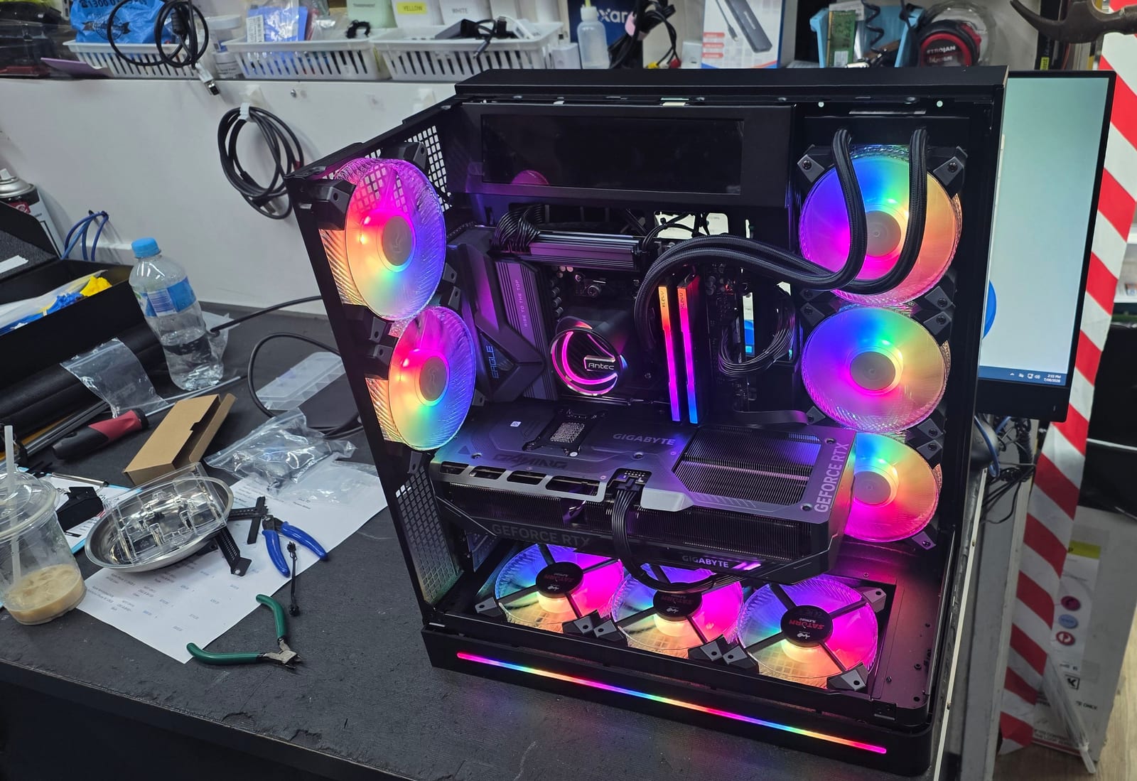 A black PC case lit purple and blue, with RGB fans on every side and a GIGABYTE GeForce RTX graphics card visible through the glass