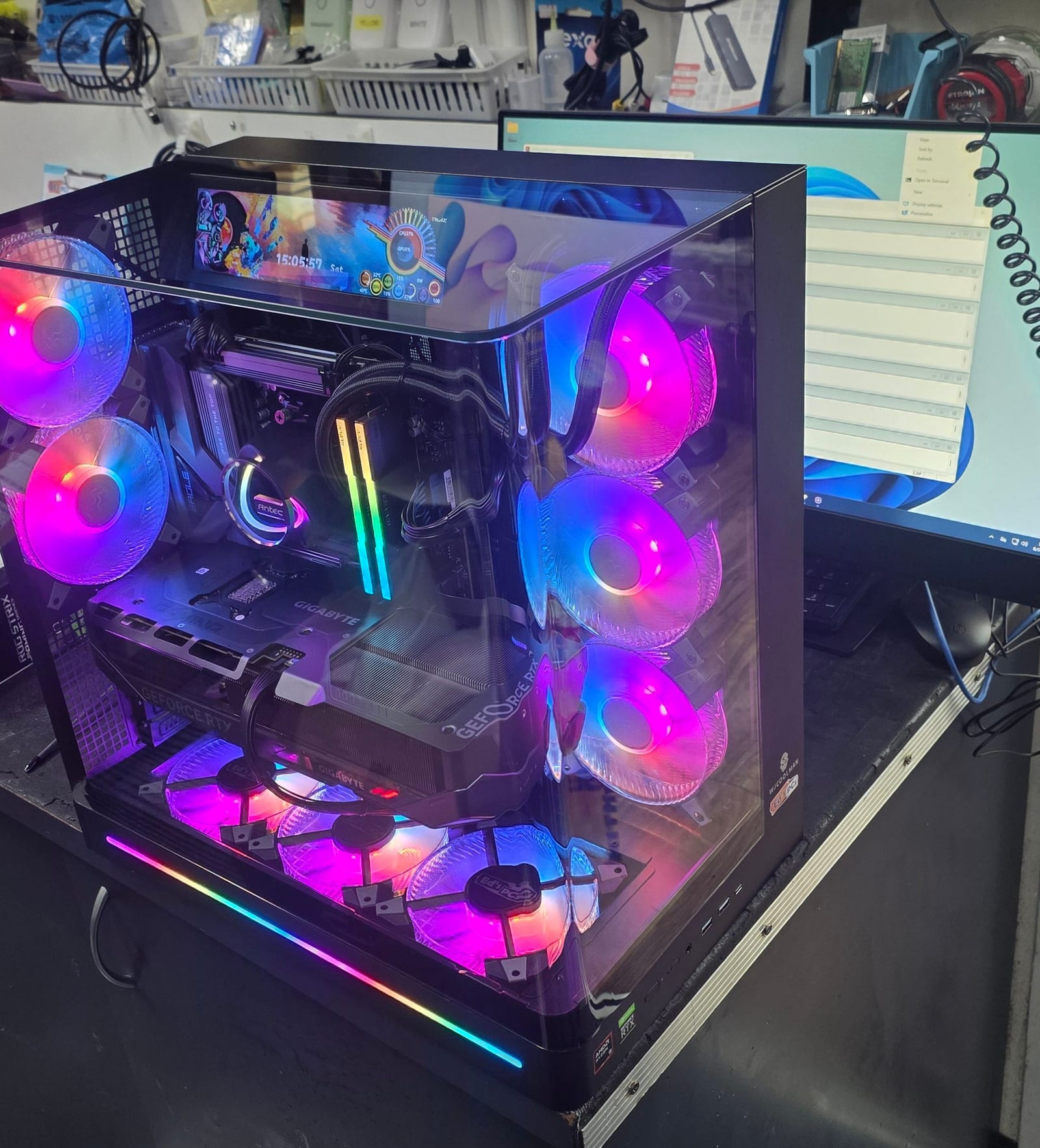 Close view into the case showing the motherboard, RGB memory and a small in-case status display