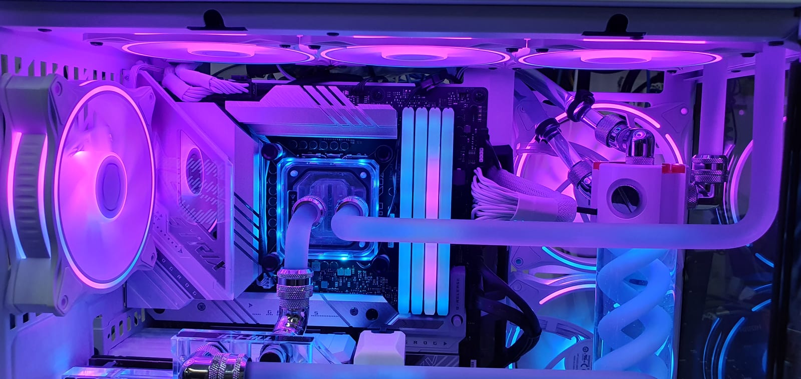 The interior of the build lit purple, showing hard-line tubing running between the processor block and the vertically mounted graphics card