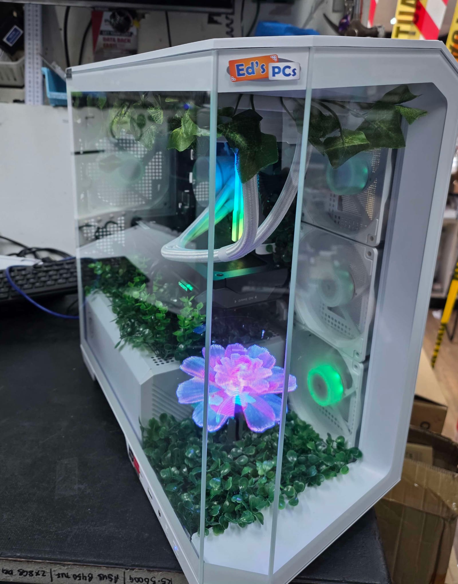 The same case from a different angle, showing a holographic flower animation and an Ed's PCs branded plate mounted on the top panel