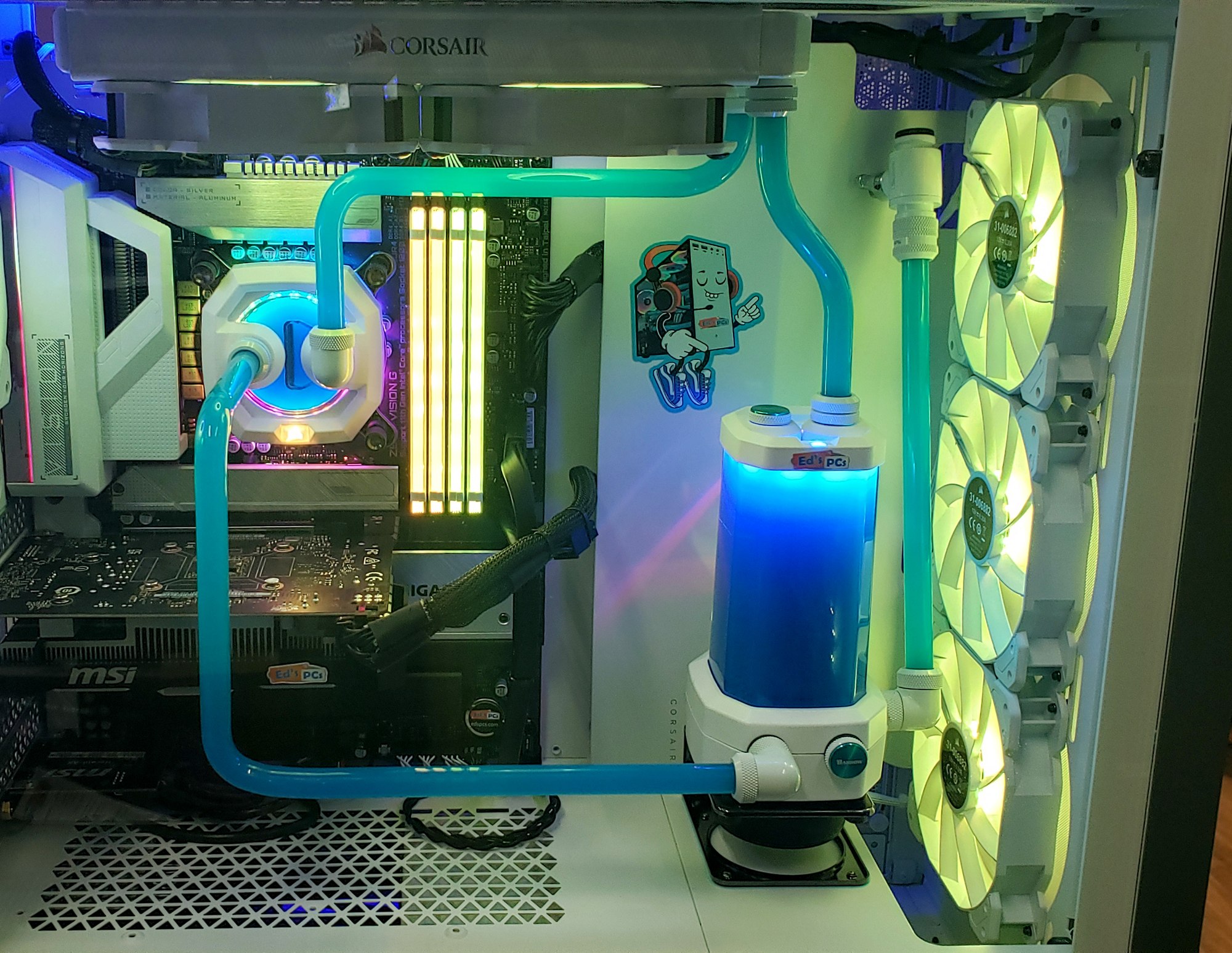 White custom gaming PC with hard-line teal water cooling loop, white Corsair fans and a lit reservoir