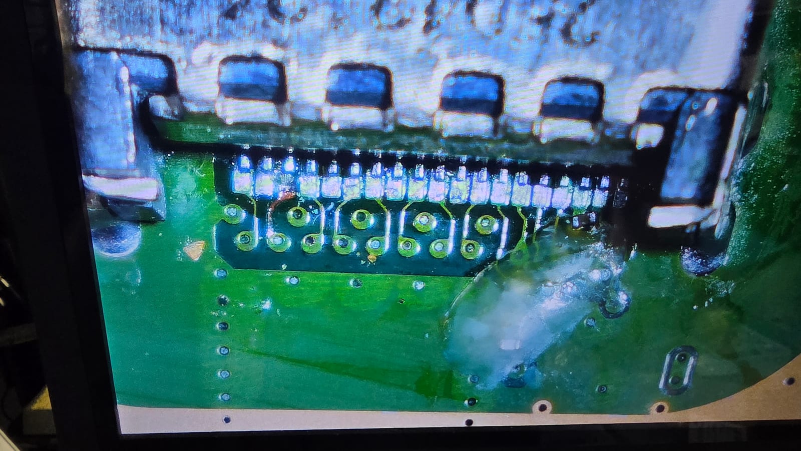 A microscope screen showing the solder joints of a replacement HDMI port at high magnification