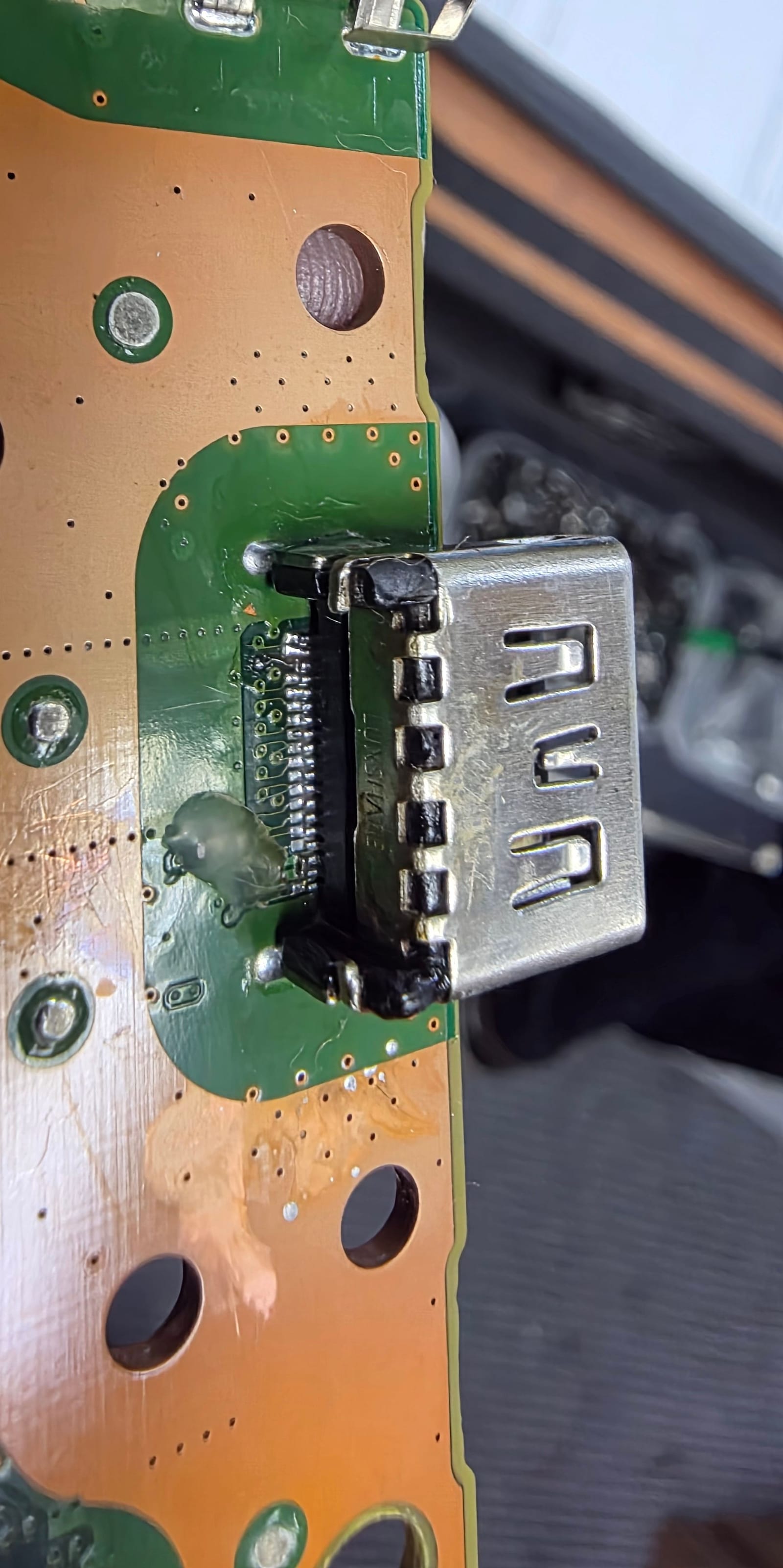 Close-up of the finished replacement HDMI port sitting flush on the PS5 board