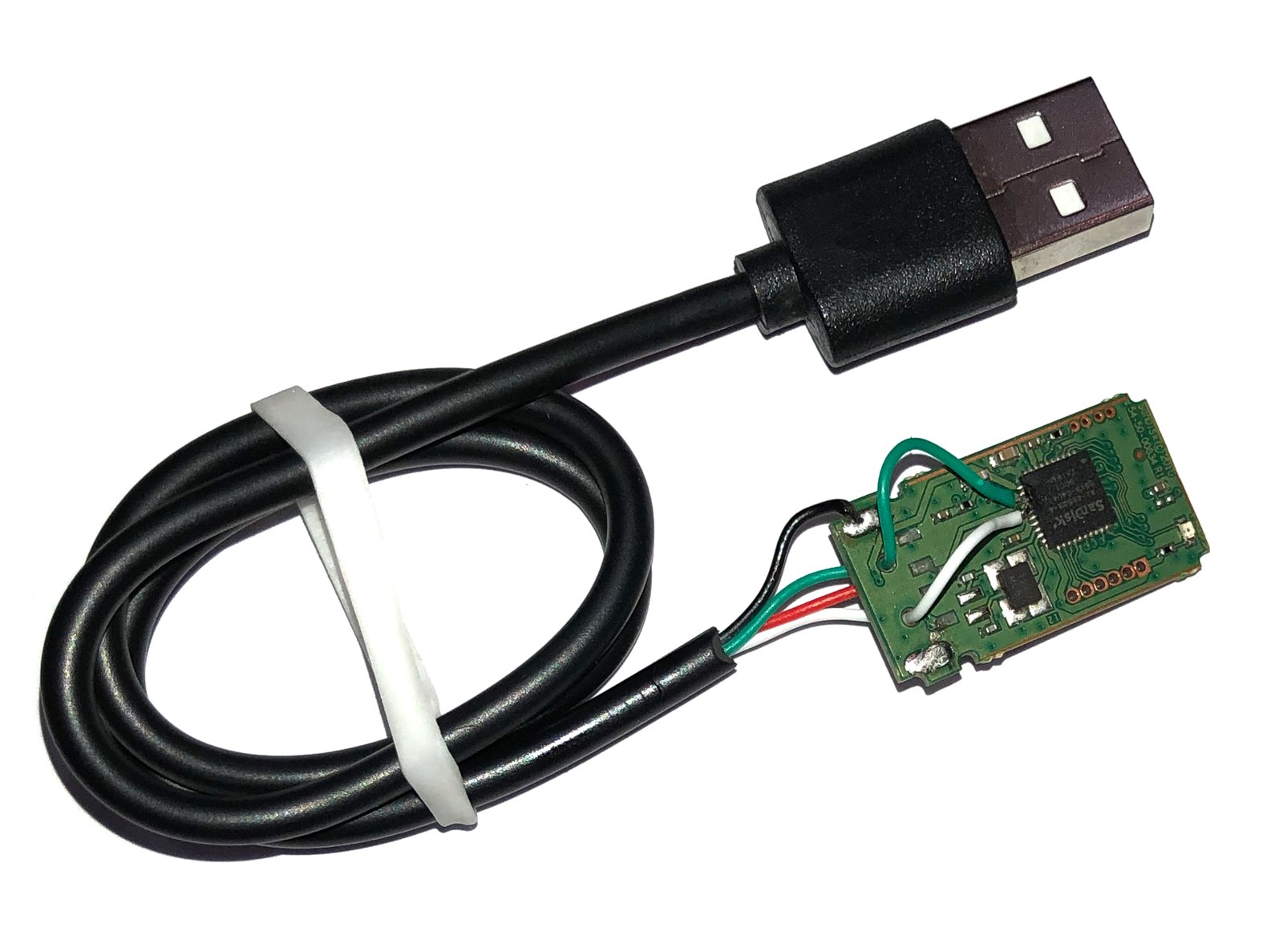 A SanDisk USB drive board with a green jumper wire bridging a damaged track alongside a soldered replacement cable