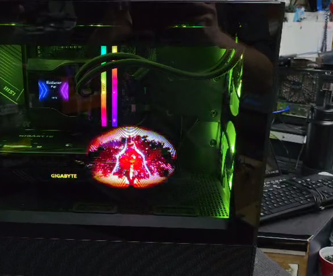This is not a screen or a video overlay. The fan blade itself is drawing the image — the same trick a persistence-of-vision poi toy uses, built into a PC.